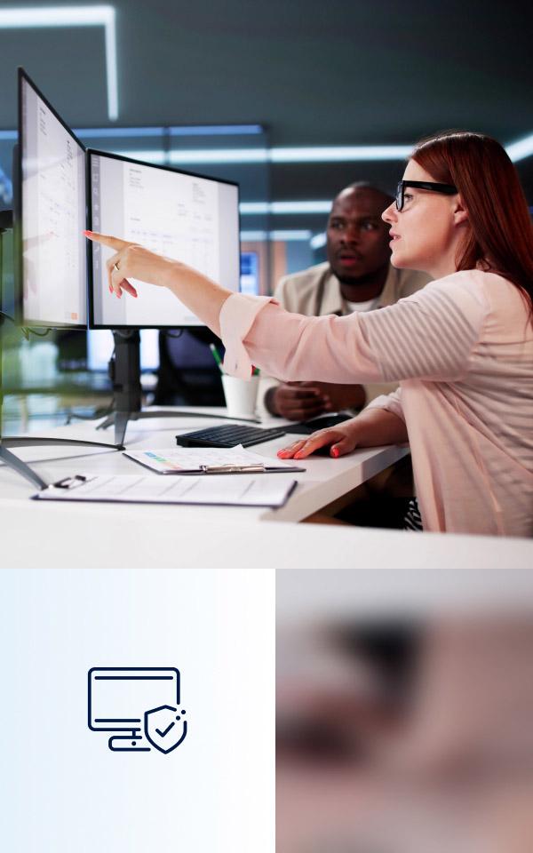 A woman points at a computer screen, illustrating Unified Exposure Management and Threat Detection for risk reduction.