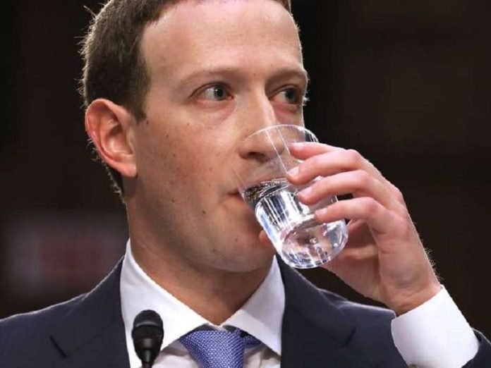 Facebook CEO, Mark Zuckerberg drinking water at the house hearing